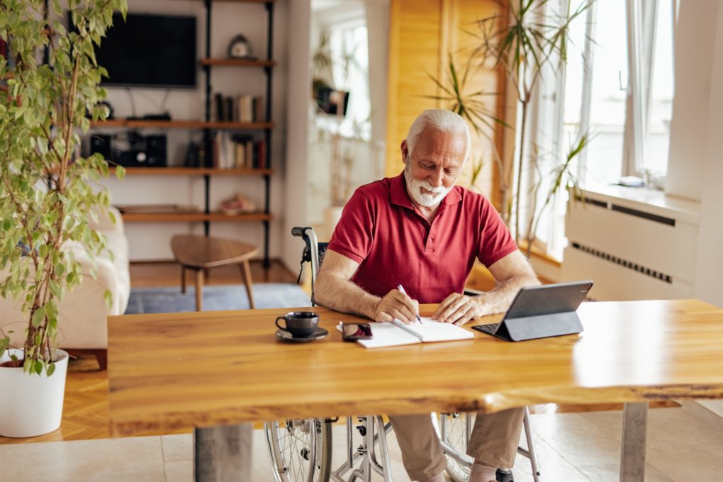 Disabled senior man, brainstorming about his new book.